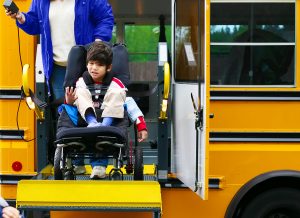 Boy using a bus lift for his wheelchair