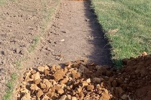 A partially completed loose stone walkway that will connect the dormitory to the school