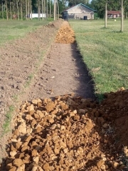 A partially completed loose stone walkway that will connect the dormitory to the school